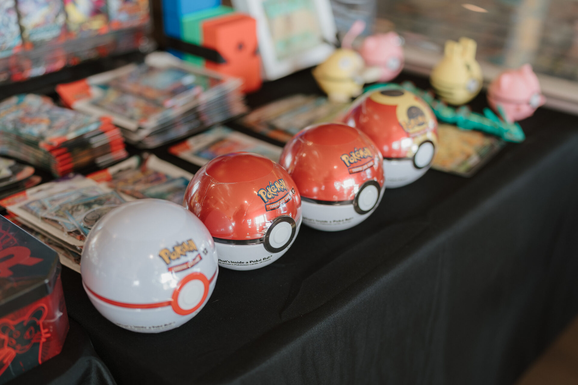 Pokémon Poké Ball tins on a vendor table