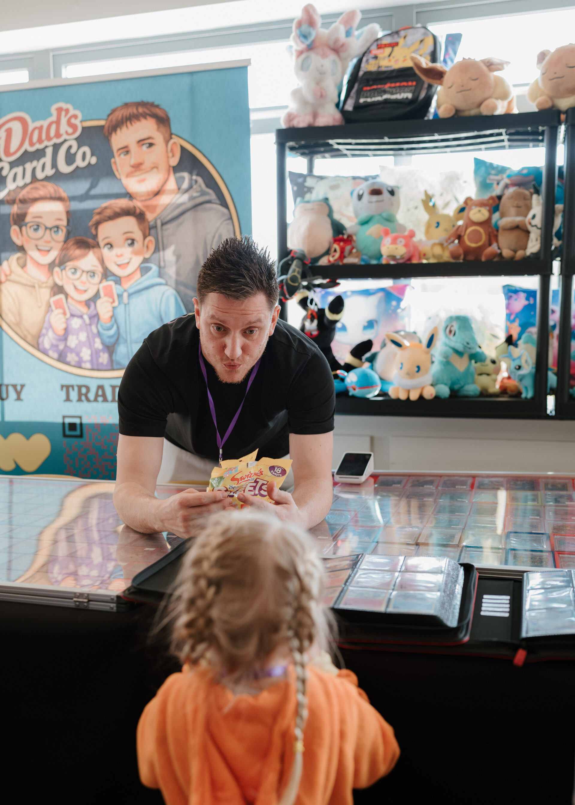 Vendor with young attendee at Dad's Card Co